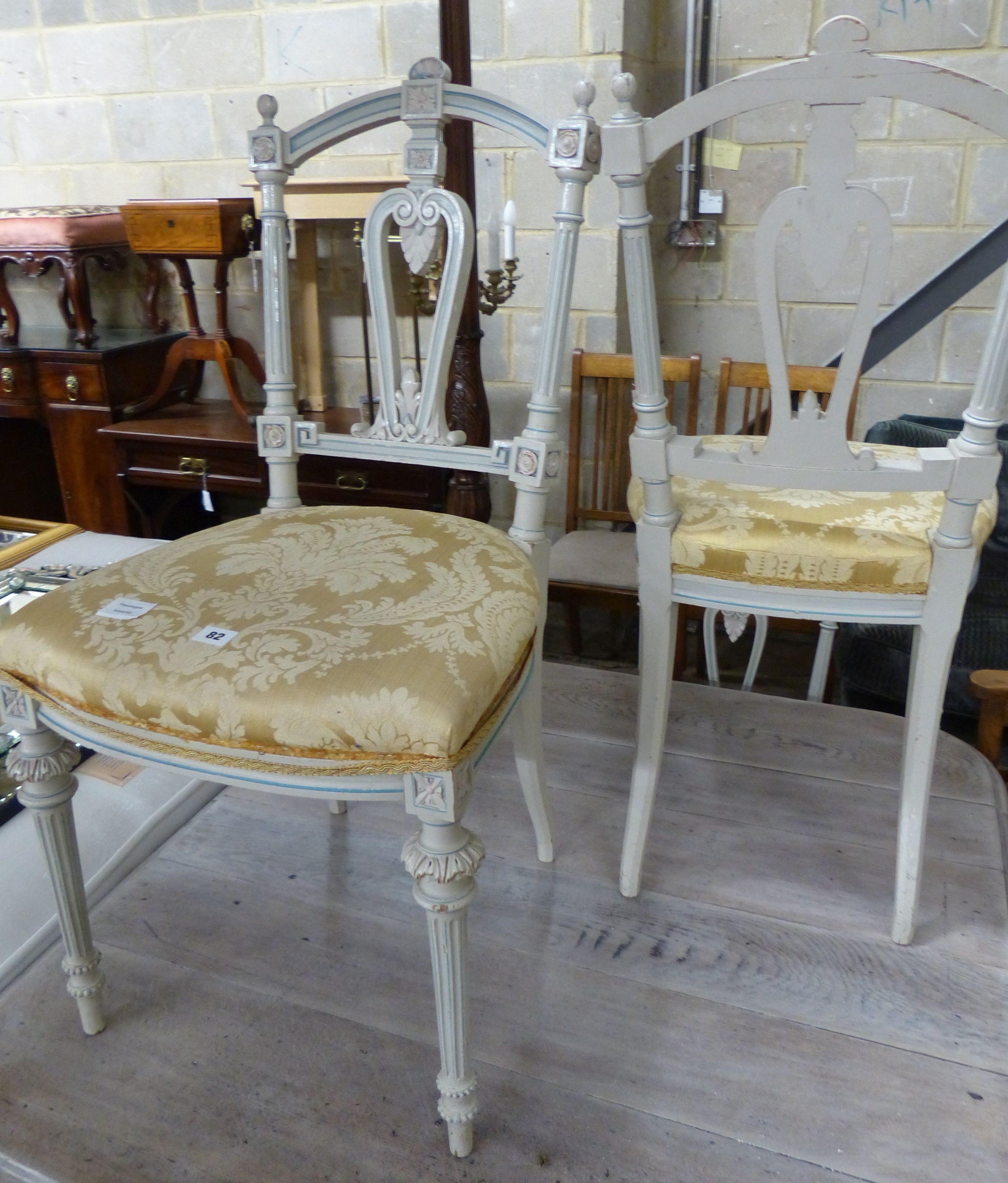A set of four French light green painted salon chairs